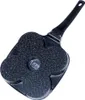 The underside of a black frying pan with a flower-shaped base and a black handle, set against a white background. Anteprima dell’immagine prodotto