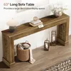 A long, narrow wooden console table with decorative elements and items placed on and around it, set against a white wall. Podgląd zdjęcia produktu
