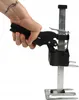 A hand is holding a furniture lifter tool. Náhled obrázku produktu