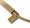 A close-up view of a gold-colored shower head and hose connection. Podgląd zdjęcia produktu