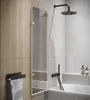 A modern bathroom with a bathtub, shower, and a glass shower screen. Produktbild-Vorschau