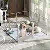 A dog is inside a clear playpen with toys and a dog bed. Anteprima dell’immagine prodotto