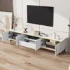 A modern TV stand with marble-look top and gold accents, featuring open compartments and drawers, set in a living room environment. Podgląd zdjęcia produktu