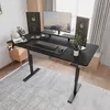 A modern home office setup with a black standing desk, dual monitors, and a plant. Náhľad obrázku produktu