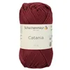 A ball of burgundy yarn with a label. Produktbild-Vorschau
