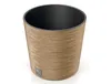 A close-up studio shot of a round, low planter pot with a textured wood-like exterior and a black interior. Náhled obrázku produktu