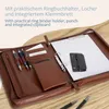An open brown leather conference folder with pens, paper, a ring binder, and a punch. Náhľad obrázku produktu