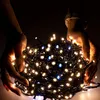 Two hands holding a tangled string of LED lights. Produktbild-Vorschau