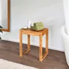 A wooden stool with towels and soap in a bathroom setting. Produktbild-Vorschau