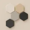 Five hexagonal tiles in different colors arranged on a light beige background. Produktbild-Vorschau