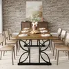 A dining room scene with a rectangular wooden dining table set for six people, surrounded by chairs, with a stone accent wall and a buffet in the background. Produktbild-Vorschau
