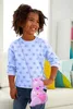 A young girl is wearing a pink kangaroo purse with a baby kangaroo inside, standing in a living room. Podgląd zdjęcia produktu