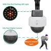 A fake security camera with a solar panel, shown with callouts highlighting its features and a cartoon illustration of a burglar running away. Produktbild-Vorschau