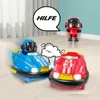 Two toy bumper cars, one blue and one red, are shown on a wooden floor. A small red robot figure stands in the background. A speech bubble above the blue car contains the German word "HILFE" (Help), and a cartoon explosion graphic is between the cars. Produktbild-Vorschau