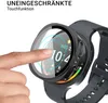 A finger is touching a smartwatch screen, which is covered by a protective case. The smartwatch displays the time and weather. Produktbild-Vorschau