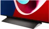 A close-up view of the bottom section of a modern television, focusing on its stand and the lower part of the screen displaying abstract colorful graphics. Produktbild-Vorschau