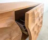 A close-up view of a wooden cabinet with a textured front and an open door revealing books inside. Produktbild-Vorschau