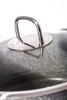 Close-up of a pot lid handle and the pot's surface. Náhled obrázku produktu