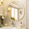 A bathroom vanity with a round mirror, sink, faucet, and decorative items. Produktbild-Vorschau