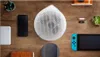 A collection of electronic devices and accessories laid out on a wooden surface. Náhled obrázku produktu