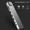 A silver USB hub with multiple ports is shown at an angle against a dark background. Text overlays highlight product features. Náhled obrázku produktu