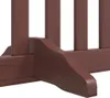 A close-up view of the base and legs of a brown wooden dog gate. Produktbild-Vorschau