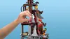 A hand is shown interacting with a LEGO structure, demonstrating a feature. Produktbild-Vorschau