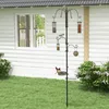 A bird feeder station with multiple feeders is set up in a grassy backyard next to a white house. Voir les images du produit