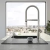 A modern kitchen sink with a faucet, set against a large window with a city view. Anteprima dell’immagine prodotto