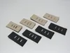 A collection of black and beige fabric extenders with metal clasps, arranged on a plain background. Produktbild-Vorschau