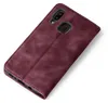 A burgundy flip cover case for a smartphone is shown at an angle on a white background. Produktbild-Vorschau