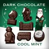 A collection of dark chocolate figures shaped like London landmarks and a Santa Claus, with a green, snowy background and text. Produktbild-Vorschau