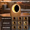 A bedside table with a moon-shaped lamp and clock. Produktbild-Vorschau