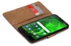 A book-style phone case with two credit cards inserted, showing a smartphone screen with a green background and app icons. Náhľad obrázku produktu