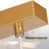 Close-up of a gold-colored metal fixture with a white cable attached, against a blurred background of sparks. Voir les images du produit