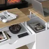 A close-up view of a lift-top coffee table with items on and inside it. Voir les images du produit