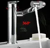A chrome faucet with water flowing into a sink, with a bar of soap on a sponge nearby. The background is dark with some greenery.