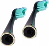 Two black toothbrush heads with green bristles and gold accents are shown against a white background. Podgląd zdjęcia produktu