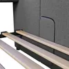 Close-up view of the wooden slats and grey fabric of a bed frame. Náhled obrázku produktu