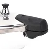 A close-up view of the handle and lid of a pressure cooker. Anteprima dell’immagine prodotto