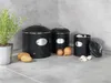 A set of three black storage containers for kitchen use, with potatoes, onions, and garlic displayed in front of them. Anteprima dell’immagine prodotto