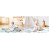 Two split images showing babies playing on a mat. The left side shows a toddler sitting and playing with a puzzle on a mat. The right side shows a baby crawling on a mat with a stuffed giraffe nearby. Voir les images du produit