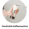 A hand holding a coffee grinder. Produktbild-Vorschau