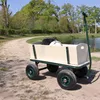 A wagon is parked on a dirt path next to a body of water, with trees in the background. Anteprima dell’immagine prodotto