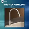 A modern kitchen faucet is shown in a close-up shot, installed in a sink. The background is a gradient of blue and light blue, with some abstract white dots on the right side. Text overlays provide product information. Produktbild-Vorschau