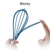 A hand is stretching a blue whisk, demonstrating its flexibility. Produktbild-Vorschau