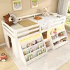 A white loft bed with integrated bookshelves and LED lighting, decorated with children's pillows and a teddy bear. Voir les images du produit