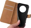 A hand holding a black phone case with a brown flip cover. Produktbild-Vorschau