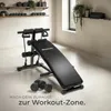 A home gym setup with a sit-up bench, dumbbells, and resistance bands. Náhled obrázku produktu
