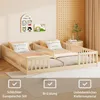 Two children's beds are set up side-by-side in a room with decorative wall art and a plant. Anteprima dell’immagine prodotto